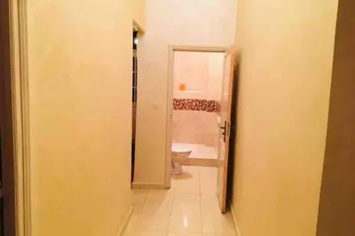 a bathroom with a toilet and a mirror in a room at Nice 2 Bedrooms Apartment near the beach in Rabat