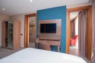 a hotel room with a bed and a tv at Address Hotel Casablanca in Casablanca