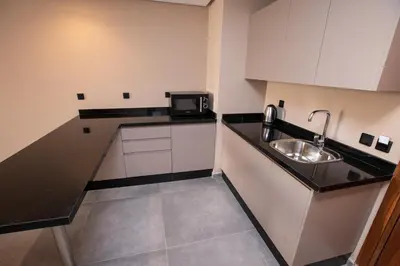 a small kitchen with a sink and a microwave at Address Hotel Casablanca in Casablanca
