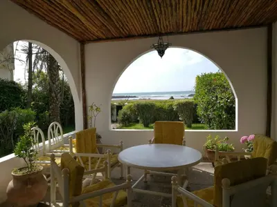 a patio with an arched window and a table and chairs at La Grande Proprit toile De Mer in Skhirat