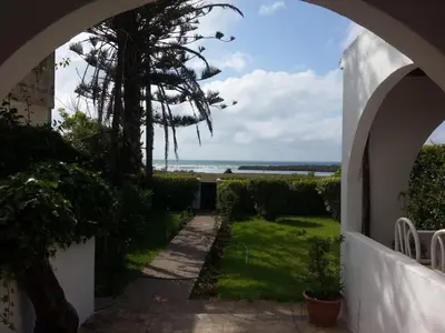 an archway leading to a garden with a view of the ocean at Maison Etoile De Mer 1 in Skhirat