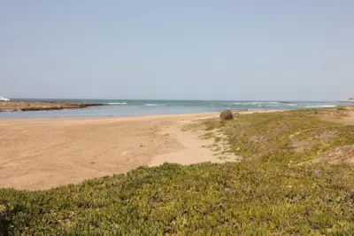 a sandy beach with the ocean in the background at Maison Etoile De Mer 1 in Skhirat