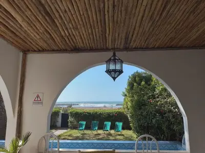 an archway with chairs and a view of the ocean at Maison Etoile De Mer 1 in Skhirat