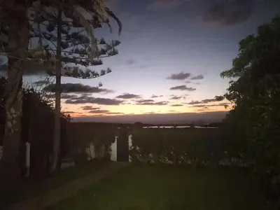 a sunset over a body of water with a tree at Maison Etoile De Mer 2 in Skhirat