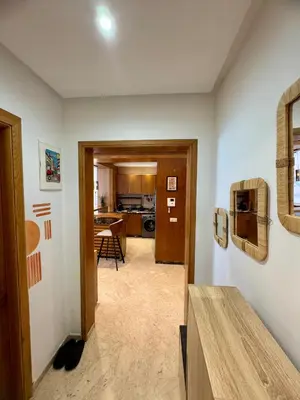 a hallway with a kitchen and a living room at Peninsula Dar Bouazza Superbe appartement en résidence avec piscine activités in Dar Bouazza