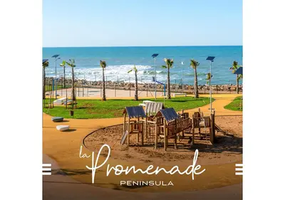 a picture of a table and chairs at the beach at Peninsula Dar Bouazza Superbe appartement en résidence avec piscine activités in Dar Bouazza