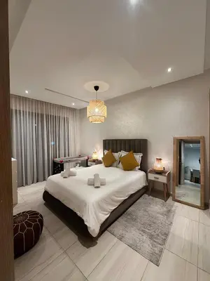 a bedroom with a large bed and a pool table at Appartement de luxe en bord de mer avec piscine in Mansouria