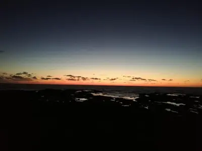a sunset on the beach with the ocean at Chez Amina in Casablanca