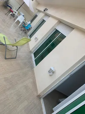 an overhead view of a building with a pool and chairs at A 5 minutes à pied de la plage un bel appartement à saisir in Sidi Rahal