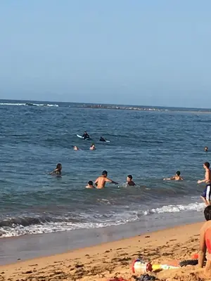 a group of people in the water at the beach at Appart. Luxueux avec piscine, cosy, bien situé in Bouznika