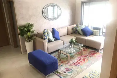 a living room with a couch and a table at Très bel appartement neuf à Mansbay Manssouria in Mohammedia
