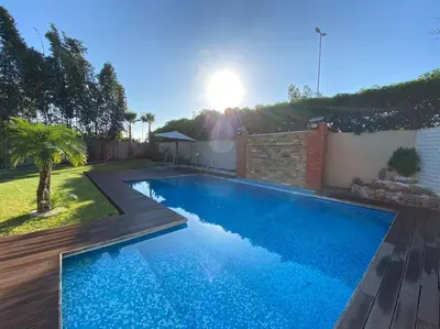 a swimming pool in the backyard of a house at Lilas Park Villa - Casablanca Bouskoura in Casablanca