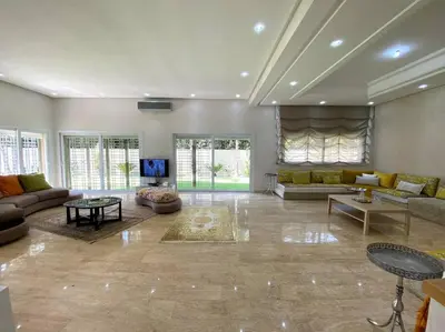 a large living room with couches and a tv at Lilas Park Villa - Casablanca Bouskoura in Casablanca