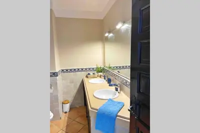 a bathroom with two sinks and a blue towel at Appartement vue mer panoramique in Tamaris