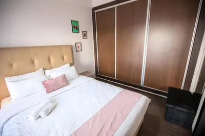a bedroom with a large bed with a brown closet at Appartement chic en plein Gauthier in Casablanca