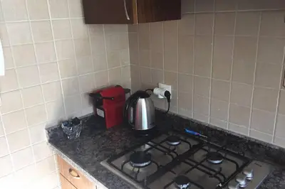 a kitchen counter with a stove top with a tea kettle at Beautiful apart Agdal in Rabat