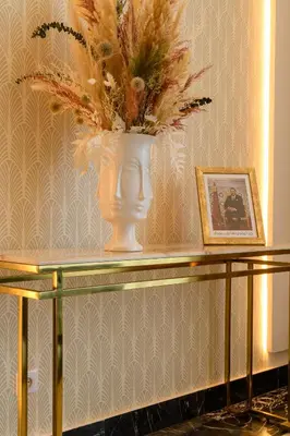 a vase with flowers on top of a table at BH Appart Hotel in Casablanca