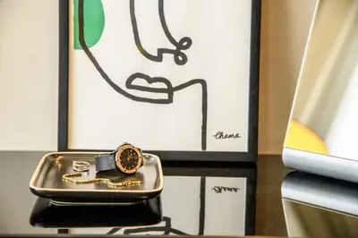 a watch sitting on a table next to a picture at BH Appart Hotel in Casablanca