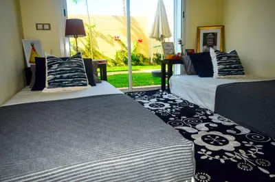 two beds sitting next to each other in a room at CASABAY Sidi Rahal, appartement avec accés direct à la plage et piscine in Sidi Rahal