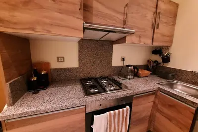 a kitchen with a stove and a counter top at CASABAY Sidi Rahal, appartement avec accés direct à la plage et piscine in Sidi Rahal