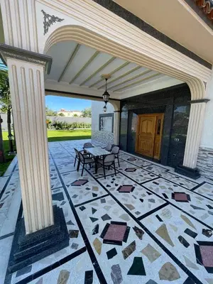 a patio with a table and chairs on a building at Villa Safaa Dar Bouazza in Dar Mouddene