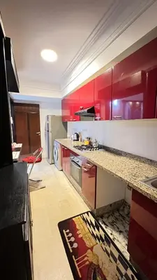 a kitchen with red cabinets and a counter top at Studio de luxe in Casablanca