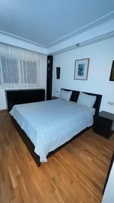a bedroom with a large bed and a wooden floor at Studio de luxe in Casablanca