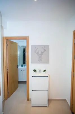 a kitchen with a white counter and an open door at My Cosy Place Rabat - Appartements à 50m de la gare Agdal TGV in Rabat