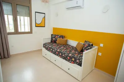 a couch with two pillows on it in a room at My Cosy Place Rabat - Appartements à 50m de la gare Agdal TGV in Rabat