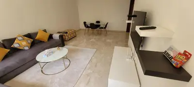 a living room with a couch and a table at Apartment Close to Casablanca Mohamed V Airport in Nouaseur