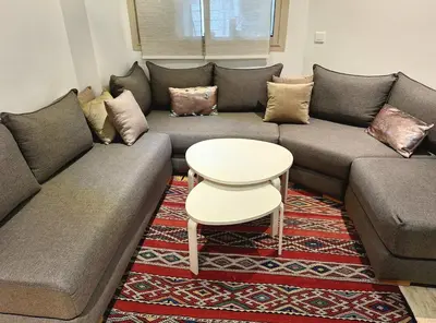 a living room with a couch and a table at Grand appartement de luxe vue mer in Casablanca