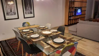 a dining table and chairs in a living room at Grand appartement de luxe vue mer in Casablanca