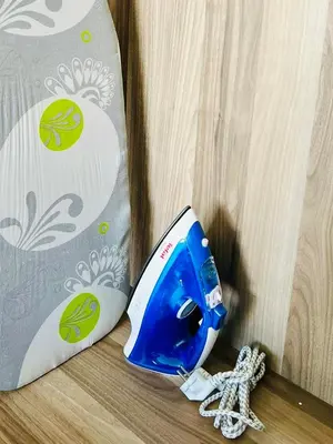 a blue and white phone sitting next to a pillow at OceanParc - Vue sur Mer et Parc 24H Sécurité in Mohammedia