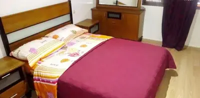 a bedroom with a bed with a pink blanket at Housse coral famille in Casablanca
