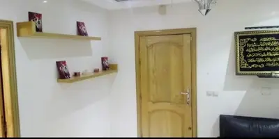 a room with a door and a sign on a wall at Housse coral famille in Casablanca
