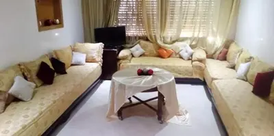 a living room with a couch and a table at Housse coral famille in Casablanca