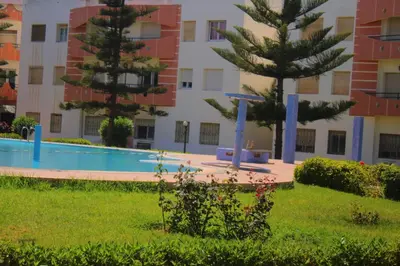 a swimming pool in front of a building at Mohammedia vive les vacances in Mohammedia