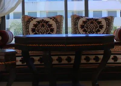 a bench with pillows on it in front of a window at Fermer Appartement dans résidence Paradis Beach in Mohammedia