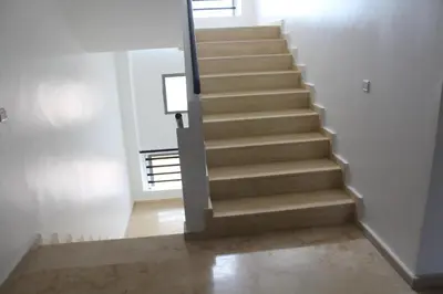 a stairway in a home with a stair case at Fermer Appartement dans résidence Paradis Beach in Mohammedia
