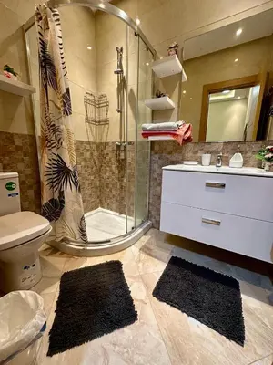 a bathroom with a shower and a toilet and a sink at Apparemment de luxe vue piscine in Bouznika