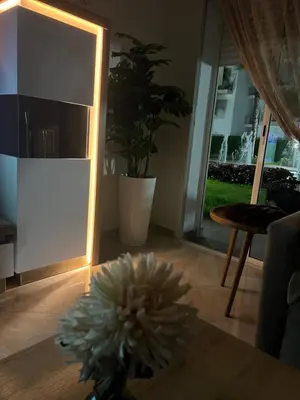 a flower sitting on the floor in a living room at Apparemment de luxe vue piscine in Bouznika