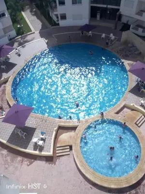an overhead view of a large swimming pool at BOUZNIKA Appartement 4 in Bouznika