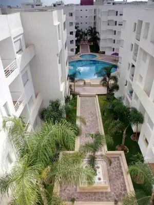 an aerial view of a building with a swimming pool at Appartement - Bouznika Centre in Bouznika