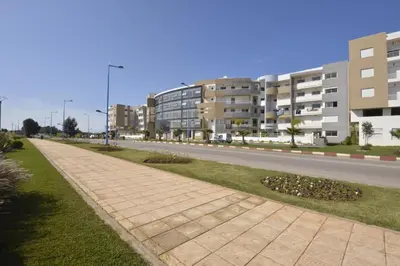 an empty street with buildings on the side of a road at Appartement - Bouznika Centre in Bouznika