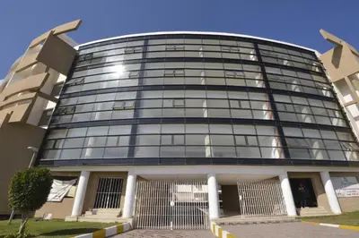 a large glass building with a lot of windows at Appartement - Bouznika Centre in Bouznika