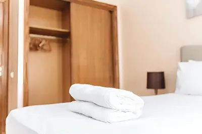 a pile of white towels sitting on a bed at STUDIO HAUT STANDING A RACINE near twin center in Casablanca