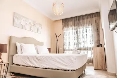 a bedroom with a large bed and a window at STUDIO HAUT STANDING A RACINE near twin center in Casablanca