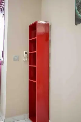 a red cabinet in a room with a wall at Gauthier studio in Casablanca