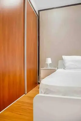 a bedroom with two beds and a wooden door at Gauthier studio in Casablanca