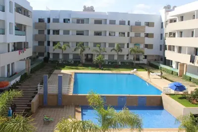 a swimming pool in front of a building at Appartement du bonheur Paradise in Mohammedia